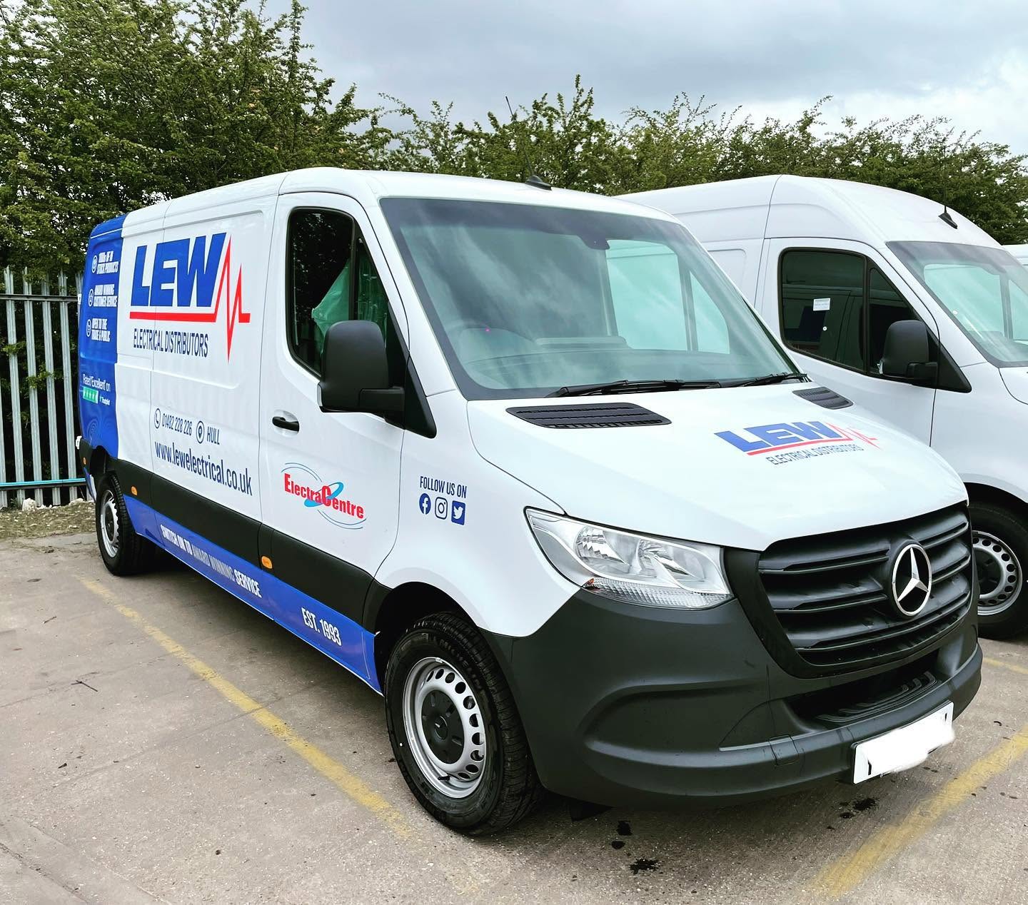 Line of clean commercial vans prepared on a fleet site