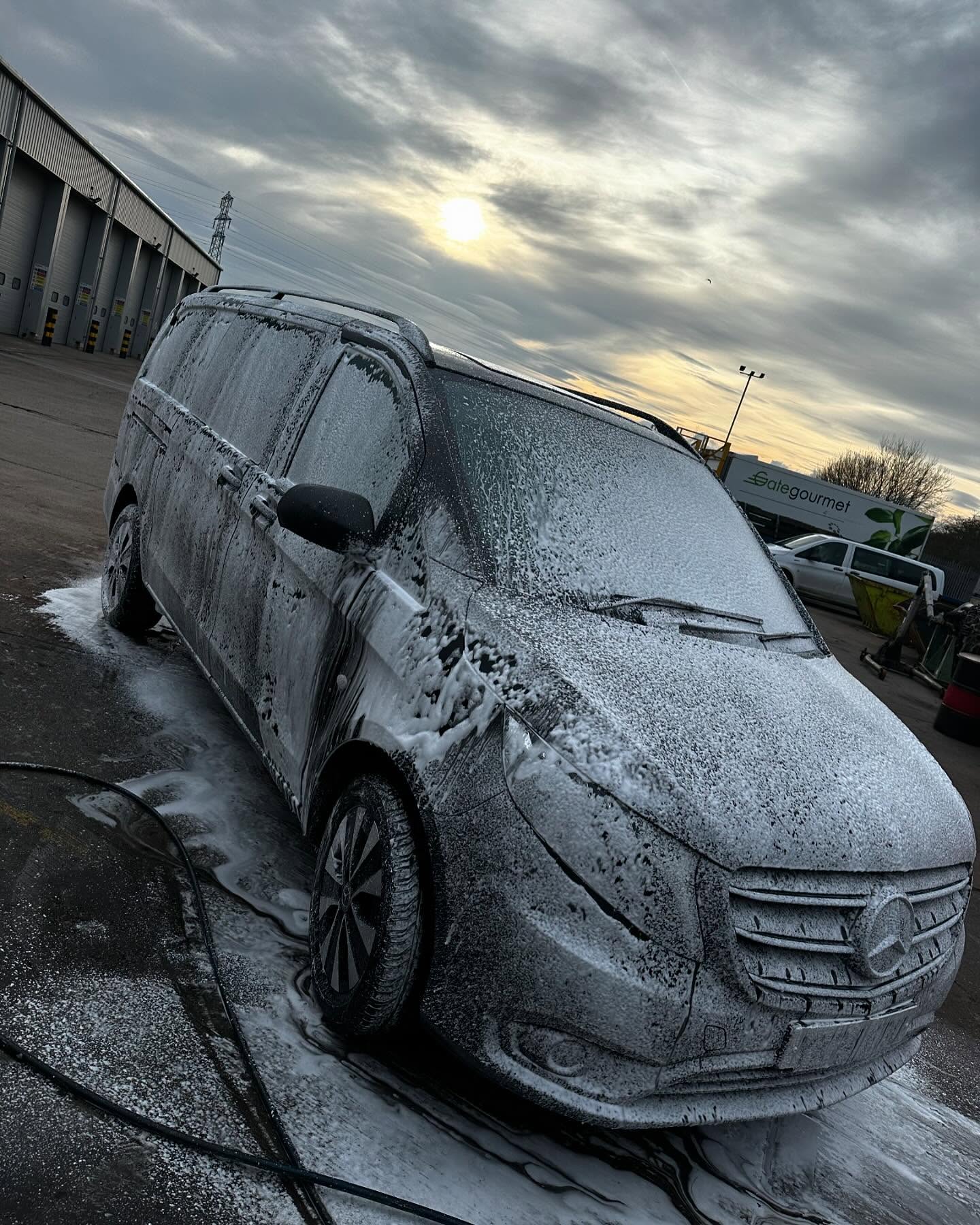 Commercial van covered in cleaning foam during an exterior deep clean